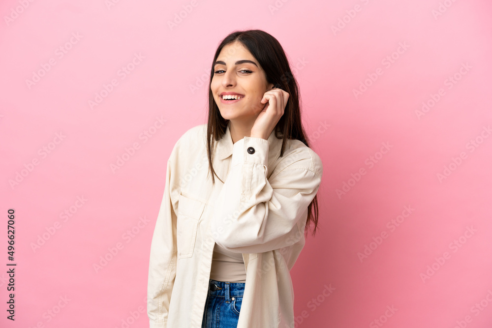 Young caucasian woman isolated on pink background laughing