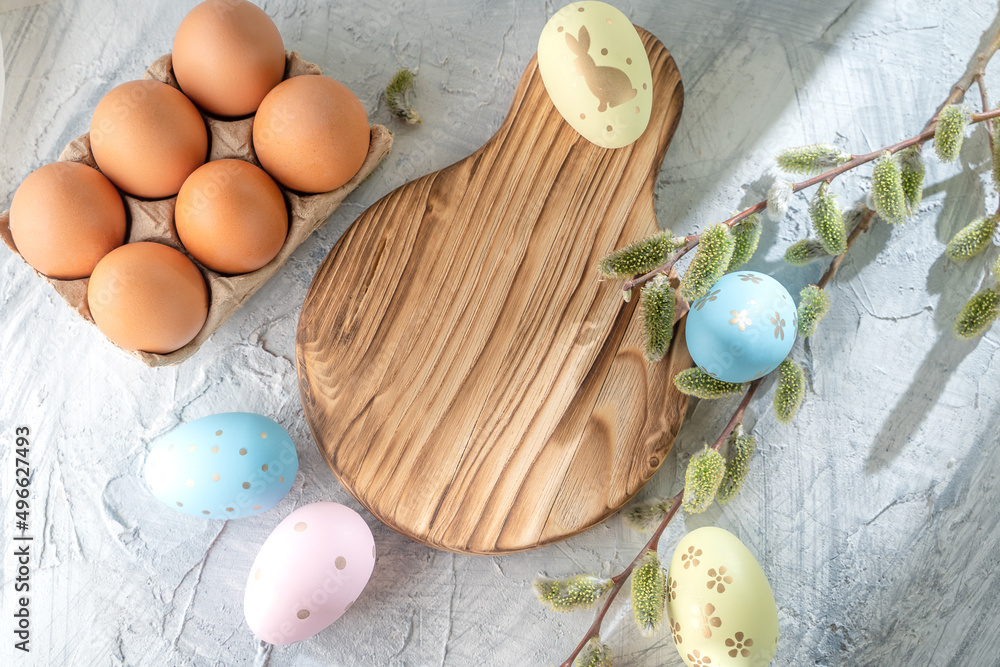 easter eggs on the table and willow, holiday symbol, top view, cultural traditions