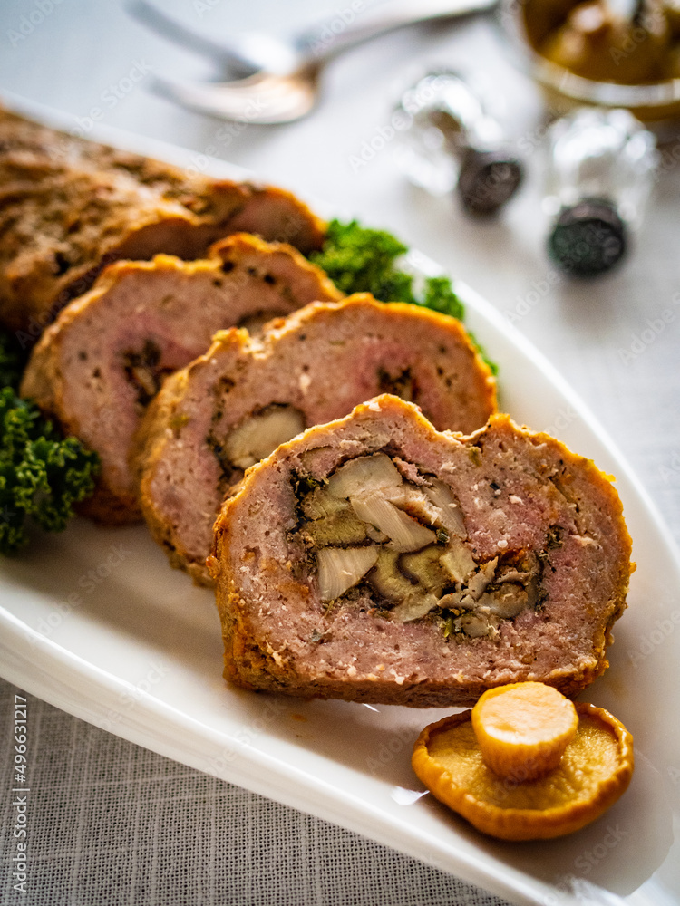 Stuffed pork minced meat with mushrooms on wooden table
