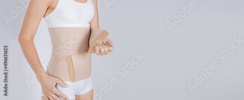 Lumbar brace on the human body isolated on a white background. Trauma of back. Back brace, orthopedic lumbar, support belt for back muscles. Lower back problems health.