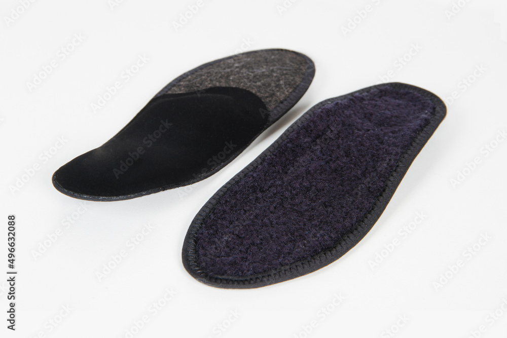 Black Insoles isolated on a white background. Medical orthopedic insoles. Foot care. Insole cutaway layers. Treatment and prevention of flat feet and foot diseases. Inner soles of shoes. Black Insoles isolated on a white background. Medical orthopedic insoles. Foot care. Insole cutaway layers. Treatment and prevention of flat feet and foot diseases. Inner soles of shoes.