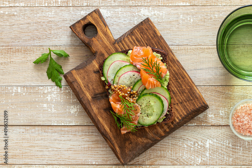 toast with rye bread, salmon, avocado photo