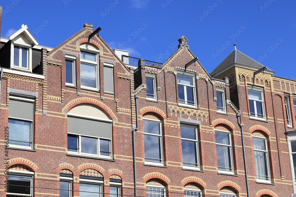 Amsterdam Paulus Potterstraat Street House Facades with Pointed Gables Against a Bright Bue Sky, Netherlands