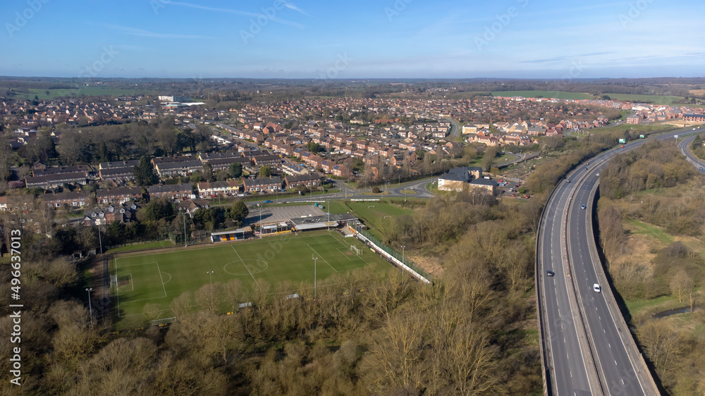 A high angle view of traffic on a dual carriageway passing next to Stowmarket in Suffolk, UK - obrazy, fototapety, plakaty 