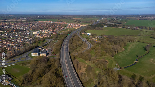 A high angle view of traffic on a dual carriageway passing next to Stowmarket in Suffolk, UK