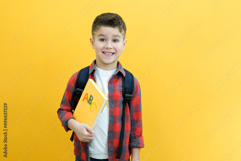 Child boy in glasses isolated on yellow paper wall. Great idea. Happy smiling schoolboy goes back to school. Success, motivation, winner Child boy in glasses isolated on yellow paper wall. Great idea. Happy smiling schoolboy goes back to school. Success, motivation, winner