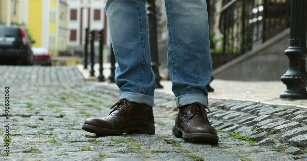 male shoes street city walk. . Men's summer fashion, stylish men's shoes. men's legs in a close-up are standing on paving stones in the city center, waiting for a date with a girl male shoes street city walk. . Men's summer fashion, stylish men's shoes. men's legs in a close-up are standing on paving stones in the city center, waiting for a date with a girl