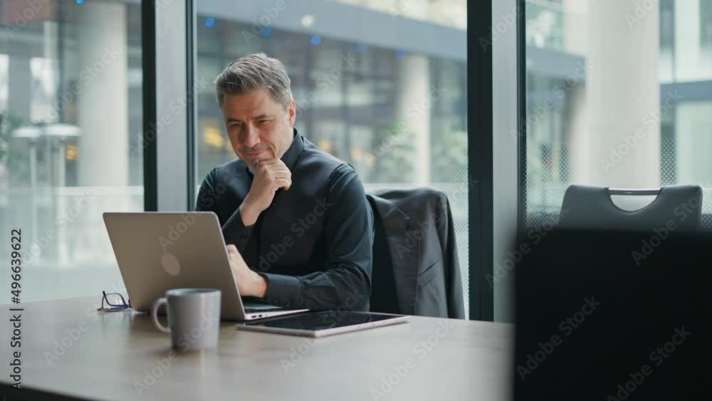 Business portrait - businessman using laptop computer in office. Happy middle aged man, entrepreneur working online. Business portrait - businessman using laptop computer in office. Happy middle aged man, entrepreneur working online.