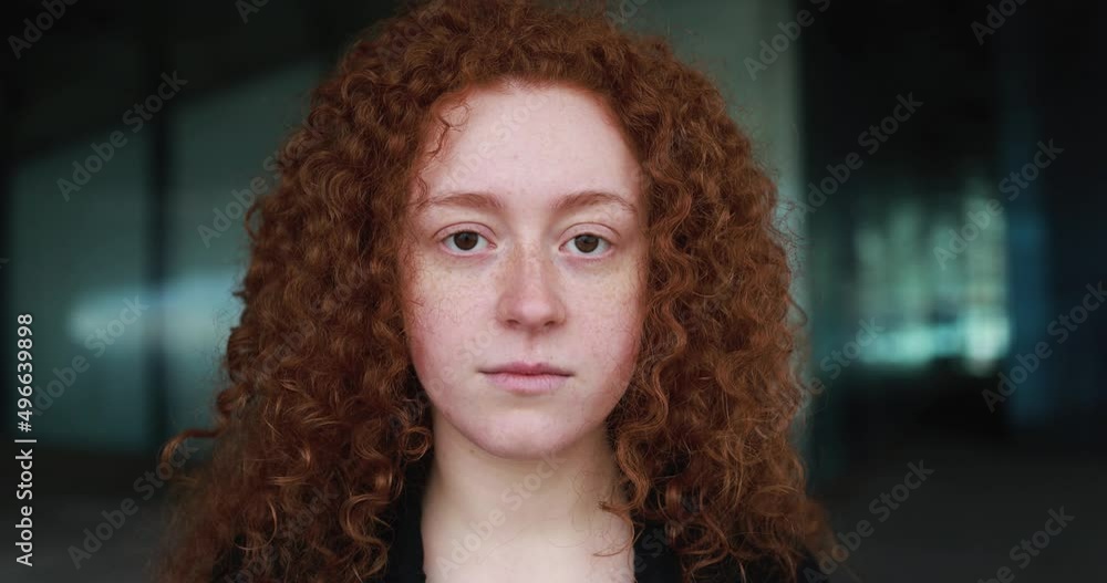 Readhead girl looking on camera outdoor