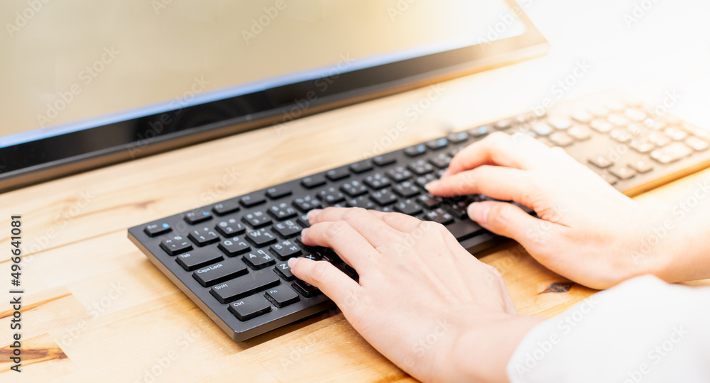 Closeup image of hands working and typing on laptop keyboard on the table for the online project incorporate software application, web surfing information online, texting email. Closeup image of hands working and typing on laptop keyboard on the table for the online project incorporate software application, web surfing information online, texting email.