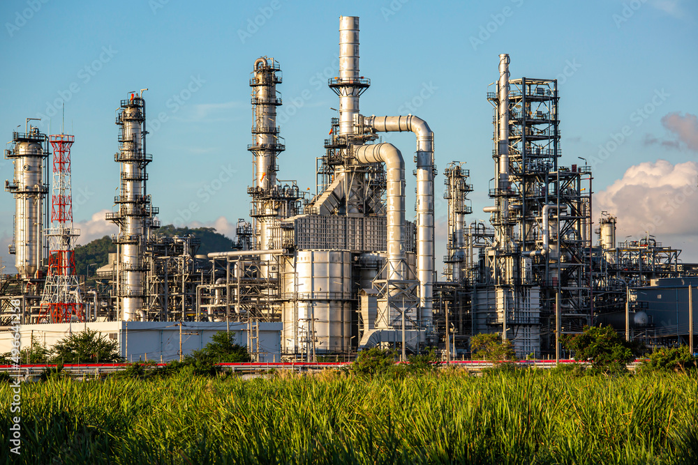 Fototapeta premium Scene evening of tank oil refinery plant tower and column tank oil of Petrochemistry industry