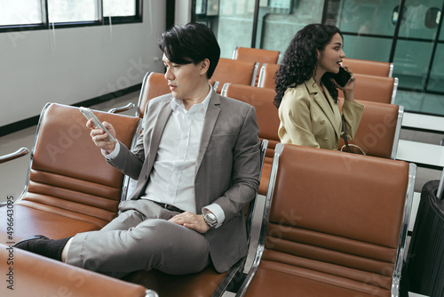 Businessman and businesswoman use smartphone at room in the airport © chachamp
