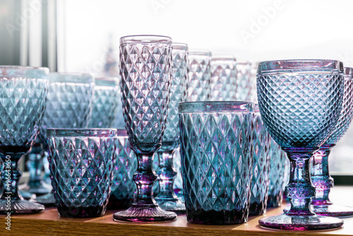 blue goblets and glasses for wine in the store on the counter transparent set collection embossed.