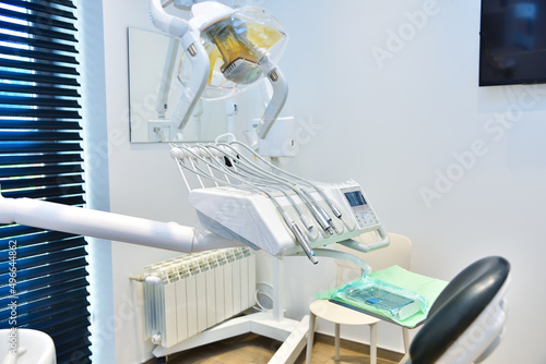 Modern dental office with chair and equipment.