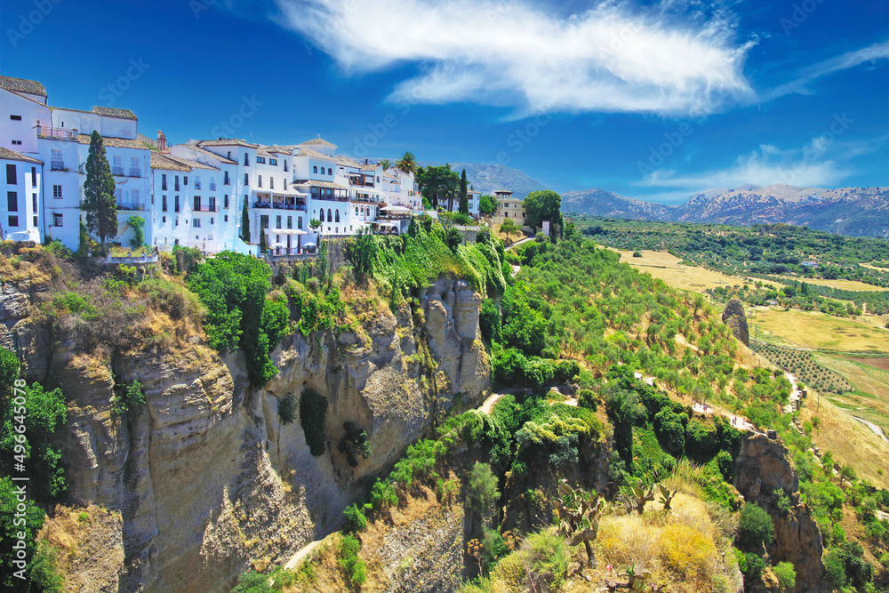 Panoramic view on ancient village Ronda located precariously close to the edge of a cliff, rural agriculture landscape background - Andalusia, Spain