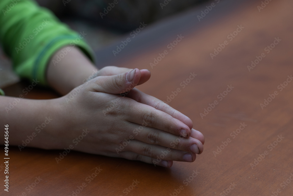 Child's hands folded together in prayer