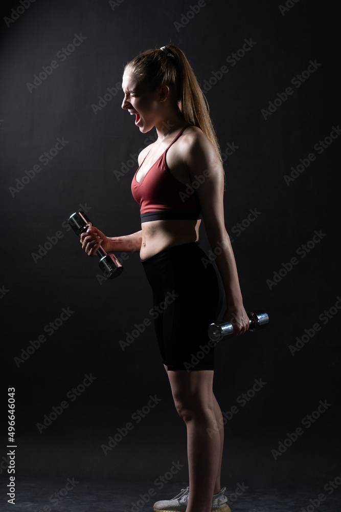 Stands beautiful a A on girl black background with dumbbells Keira Knightley girl dumbbells fitness caucasian, In the afternoon health fit in young and active isolated, beautiful wellness.