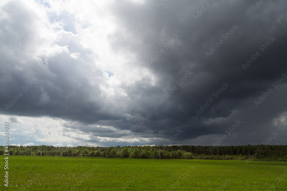 Real rain from the clouds. Picturesque cyclone storm clouds before rain and thunder. Atmospheric cloudscape. Weather forecast by meteorological observations. Real rain from the clouds. Picturesque cyclone storm clouds before rain and thunder. Atmospheric cloudscape. Weather forecast by meteorological observations.