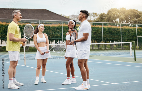 Listen to your coach. Full length shot of a handsome mature male tennis coach talking to his students out on the court. © Siphosethu Fanti/peopleimages.com