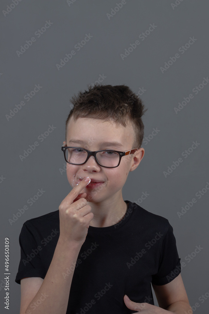 A teenage boy smears pimples on his face with cream, a child has herpes and treats sores