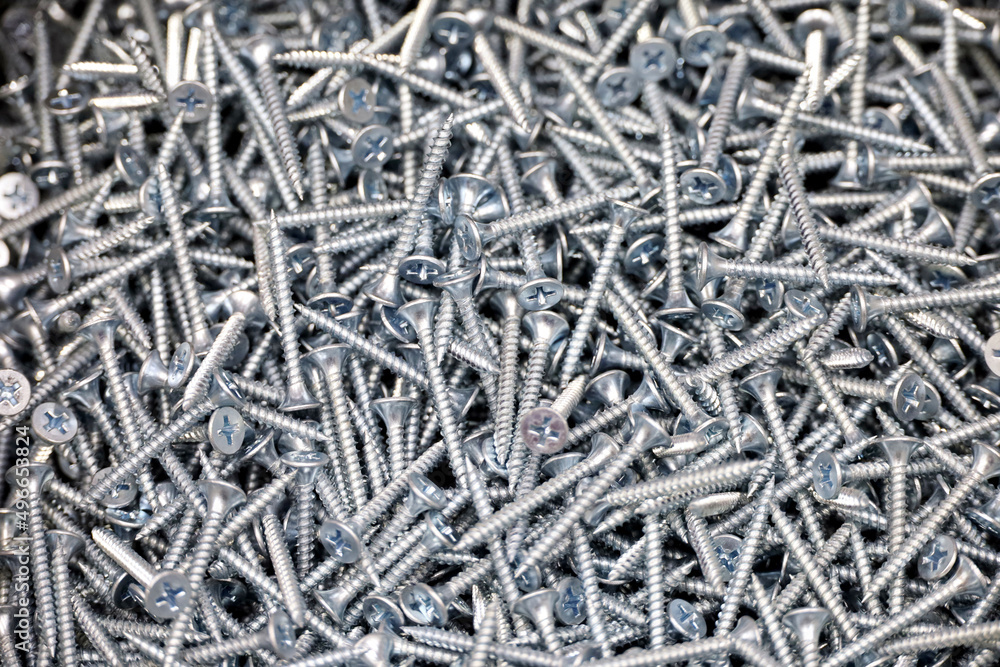 Self-tapping screws in a store, selective focus. Background for construction industry Self-tapping screws in a store, selective focus. Background for construction industry