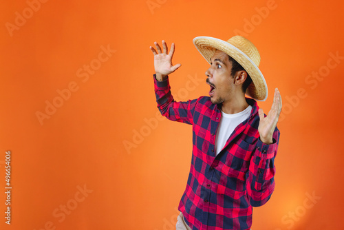 Black Man With Junina Party Outfit Scared Isolated on Orange Background.