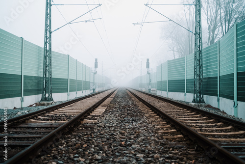 Railroad noise barrier. Acoustic wall reducing train sound. Soundproof protection fence along the railway.