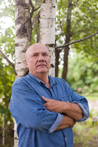 Fototapeta Naklejka Na Ścianę i Meble -  Portrait of senior man near birch trees in summer