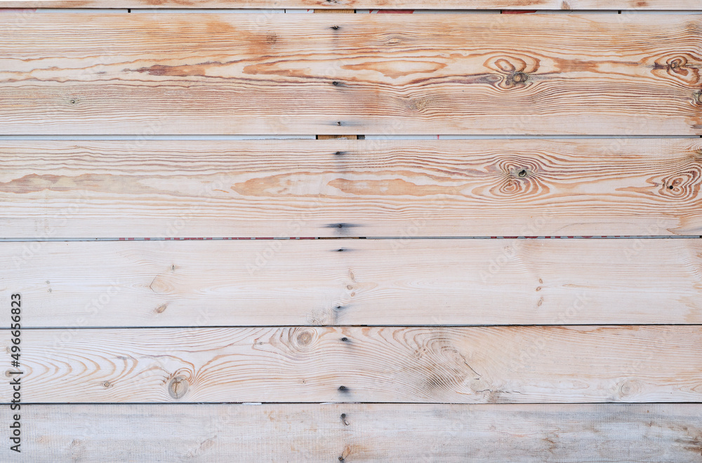 Naklejka premium Wooden background of horizontal pine boards covered with knots.