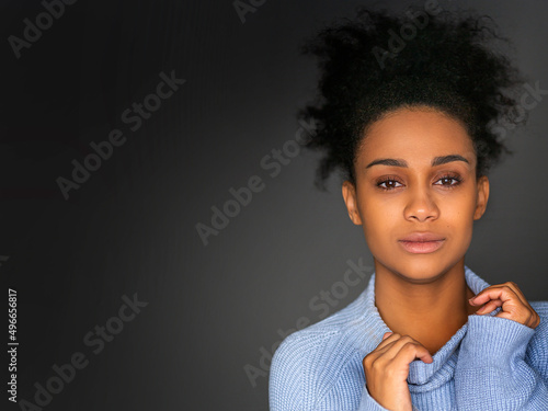 Close up portrait of a 30 year old pensive african american woman lookingat camera - psychology and women's health concept. photo