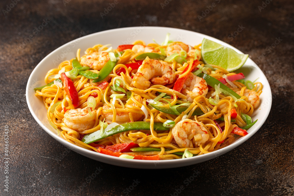 Stir fry noodles with prawns and vegetables in white plate. Healthy asian food
