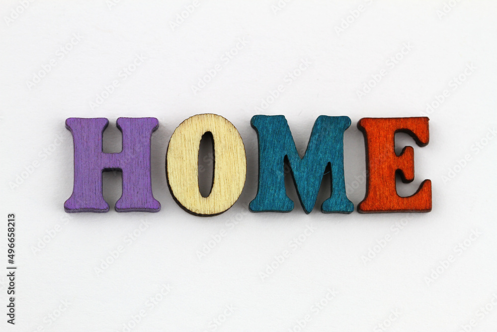 Word home written with colorful wooden letters on white surface