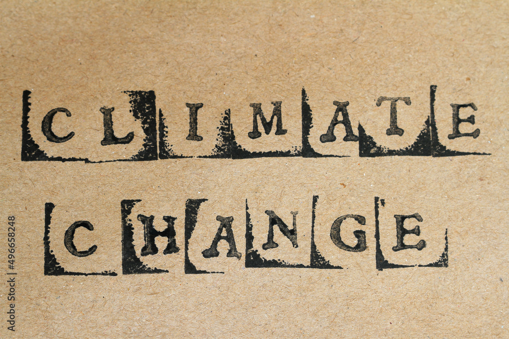 Word climate change made with letter stamps on grey hand made paper