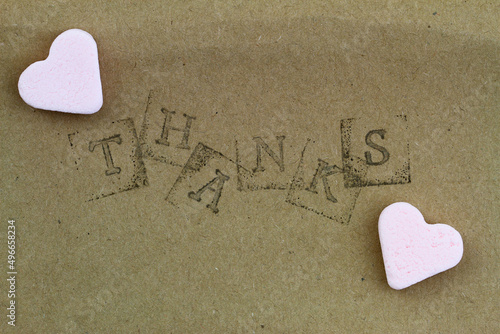 Obraz na płótnie Word thanks made with letter stamps with two pink sugar hearts
w salonie