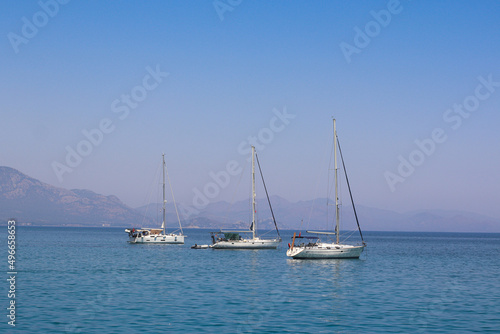 Sailing yacht in the sea against the backdrop of mountains © Дмитрий Горелкин
