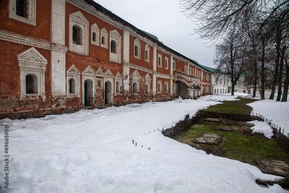 A beautiful old building. Red brick facade. Old beautiful architecture. Winter day. Cloudy weather. Snowy winter day. A beautiful old building. Red brick facade. Old beautiful architecture. Winter day. Cloudy weather. Snowy winter day.
