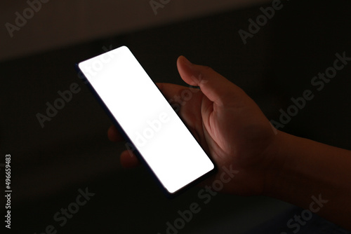 White Screen of the mobile phone on right hand.