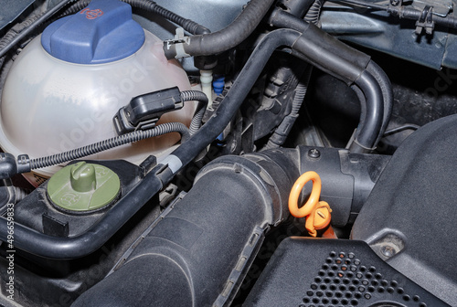 Car coolant reservoir and parts of the engine compartment