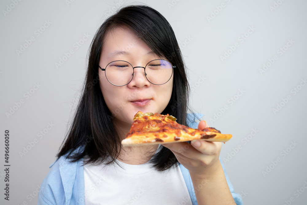 Happy glasses Asian young woman eat Pizza on white background. Happy glasses Asian young woman eat Pizza on white background.