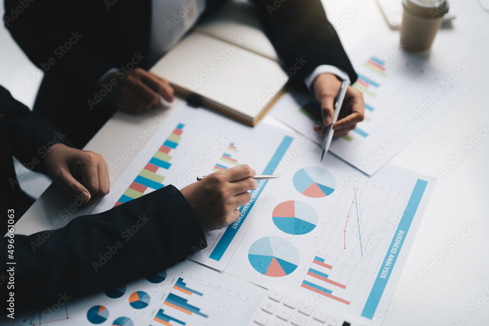 young business team meeting in the office talk about analyses chart graph marketing plan with computer laptop calculator young business team meeting in the office talk about analyses chart graph marketing plan with computer laptop calculator