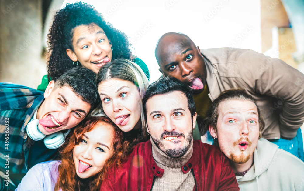 Multicultural guys and girls taking funny selfie out side - Happy life style concept by young multiethnic friends having fun together - Bright vivid backlight filter - Focus on mid mustache guy Multicultural guys and girls taking funny selfie out side - Happy life style concept by young multiethnic friends having fun together - Bright vivid backlight filter - Focus on mid mustache guy