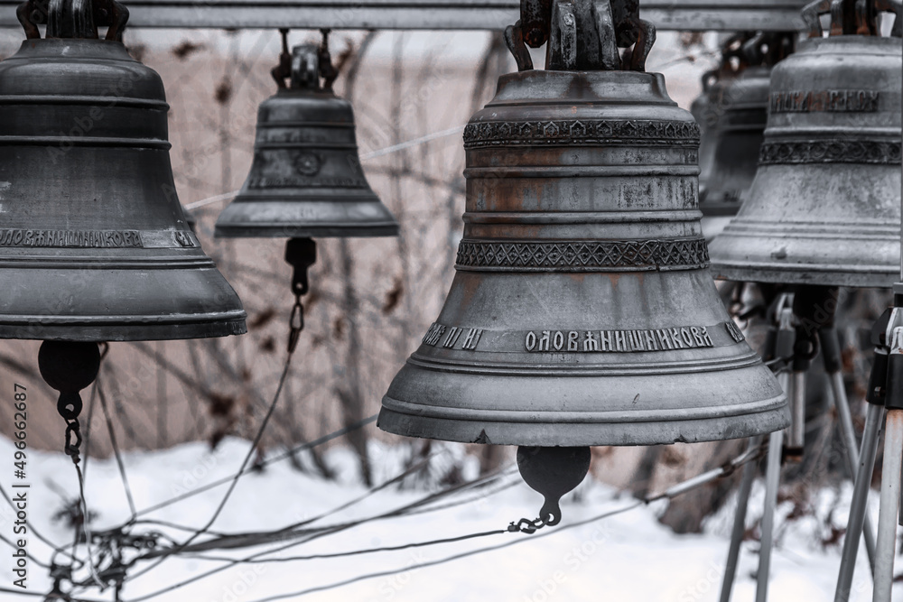 Obraz premium Ancient metal bells. Religious church bells. Rusty old bells. Winter gray snowy day.