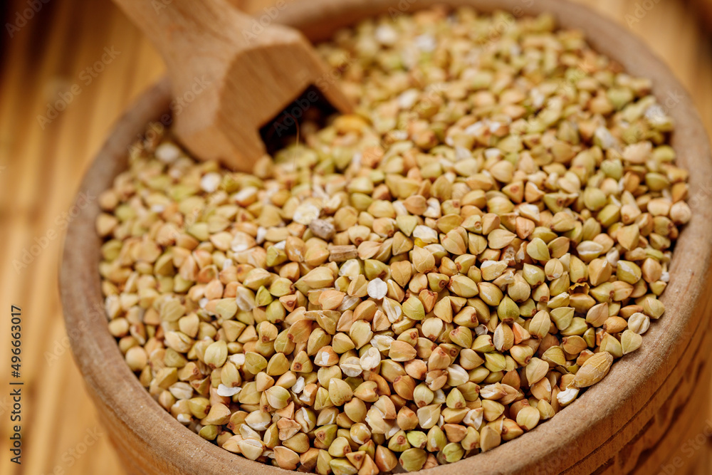 Buckwheat groats in bowls and bags on a wooden background. High quality photo