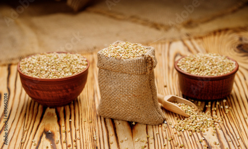 Buckwheat groats in bowls and bags on a wooden background. High quality photo