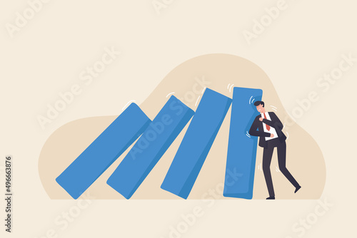 Surviving from job duties and persist in the economic crisis. Patience and adaptation in business to success. Businessman trying to stop dominoes from falling.