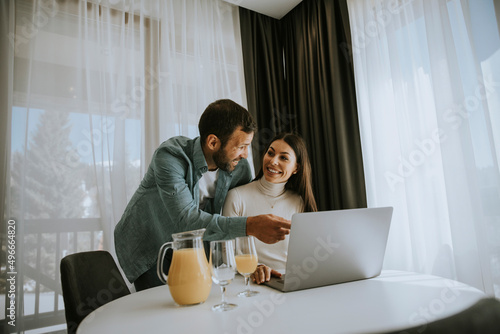 Young couple using laptop c...