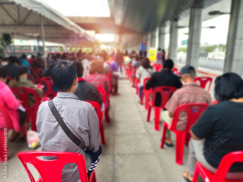 many people waiting for covid 19 vaccination,young man and many people waiting medical and health services to the hospital, servicepatients waiting treatment at the hospital