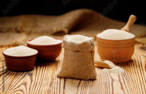 Semolina in bowls and bags on a wooden background. High quality photo
