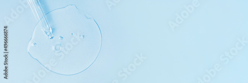 Cosmetic oil, serum or serum and pipette on a light blue background. Banner. Place to copy. photo
