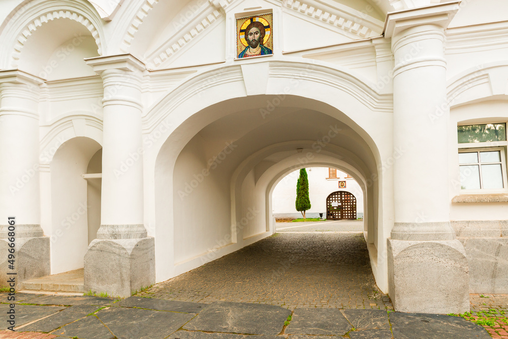 Gate of white stone building in Valaam monastery, Russia